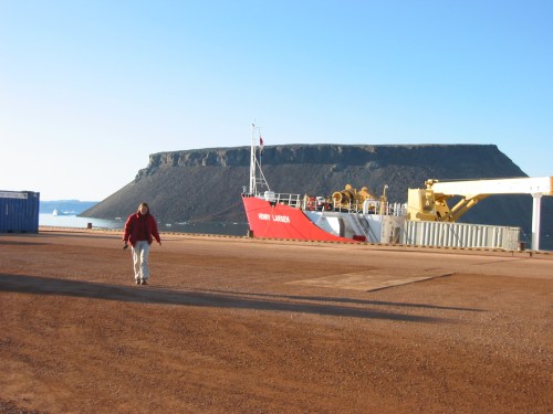 Dr. Helen Johnson in August 2009 on the pier of Thule AFB with CCGS Henry Larsen and Dundas Mountain in the background. [Credit: Andreas Muenchow]