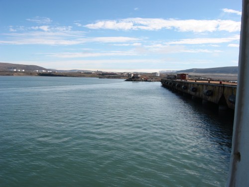Pier at Thule in Aug.-2012 with the Air Force Base and the Greenland Ice Sheet in the background. [Credit: Andreas Muenchow]