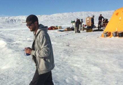 Peter Washam on Petermann Gletscher at an ice drilling camp. Cables and ropes against tent are used later to connect ocean sensors to the weather station.