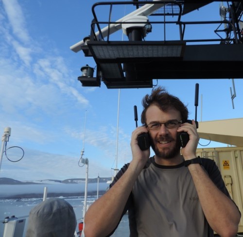 Rob Holden testing Iridium phones above the bridge of I/B Oden.
