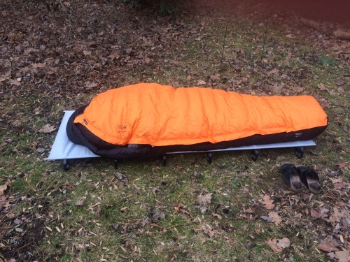 Cot, air mattress, and down sleeping bag testing in my garden after a rough night.