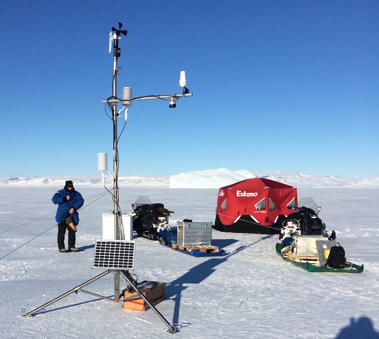 Installation of Automated Weather Station on Mar.-23, 2017 near Thule, Greenland via snowmobile. The station includes a satellite connection to the internet and a cable to the ocean.